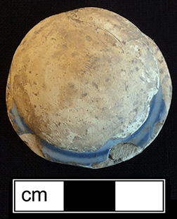 Tin glazed earthenware knobbed lid that has been shaped into a gaming piece - from 18CV91.